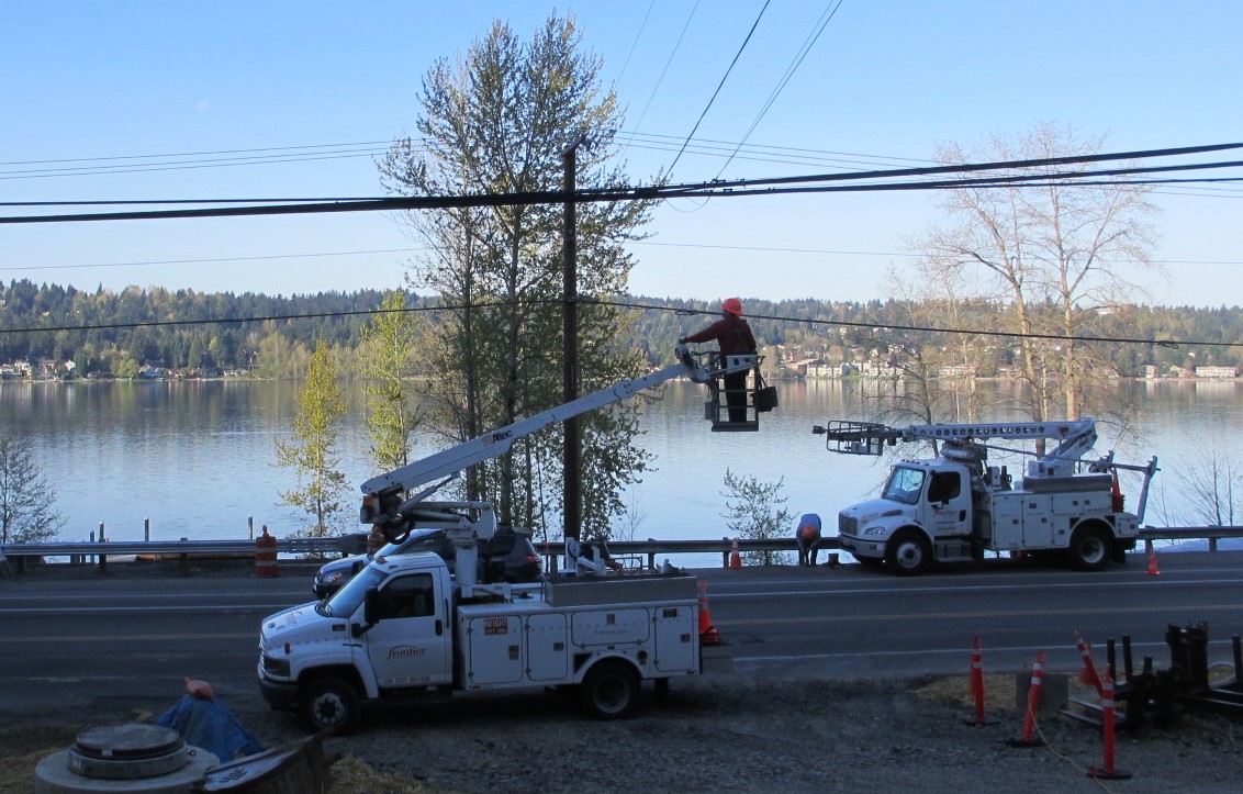 utility trucks and linemen working
